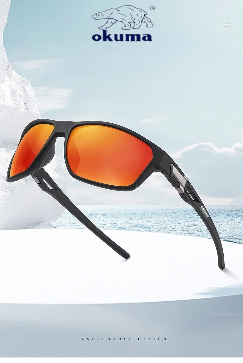 A pair of black sports sunglasses with bright orange lenses resting on a white surface against a blue sea background.