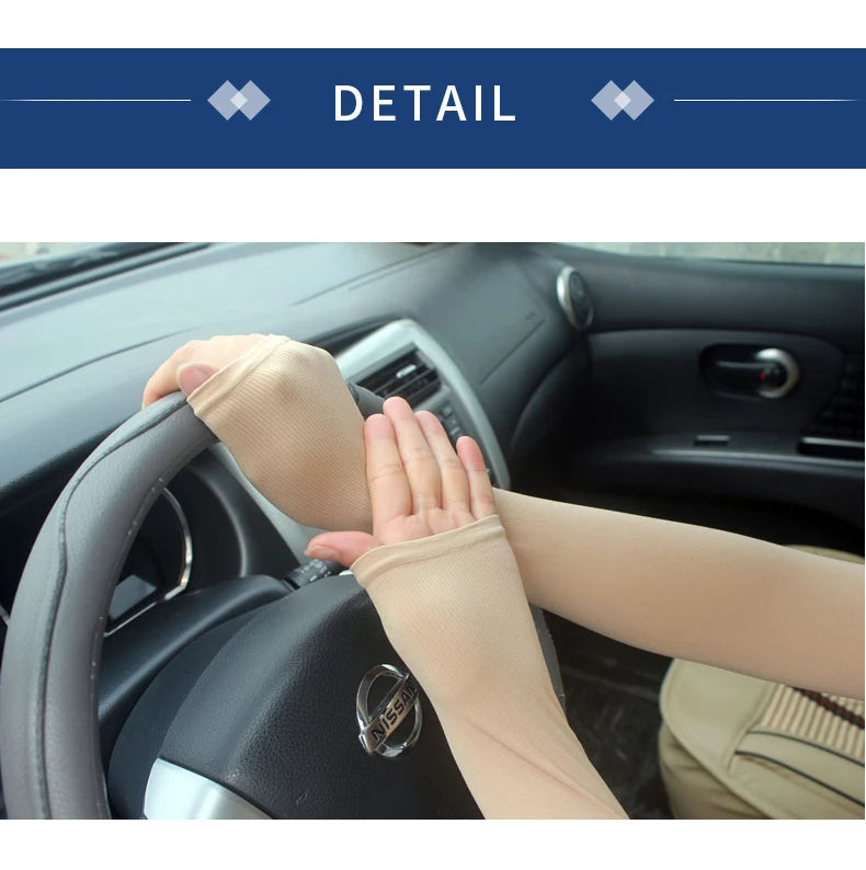 A hand wearing a beige breathable arm sleeve is gripping a car steering wheel.