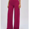 A model wearing magenta high-waist wide-leg yoga leggings and silver athletic shoes.