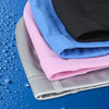 A stack of various colored swim caps, including pink, blue, and gray, resting on a blue surface.
