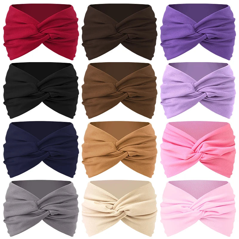 A collection of eight folded twisted criss cross elastic headbands in various shades of red, brown, purple, and pink.