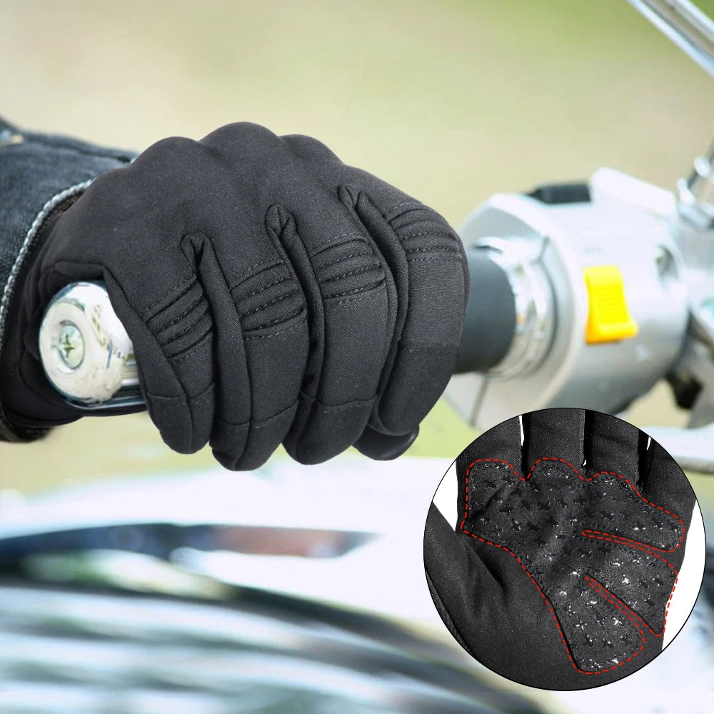 Close-up of a hand wearing black motorcycle riding gloves with red stitching detail.