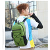 A young man wearing a white and blue shirt and khaki pants is carrying a large green backpack outdoors.