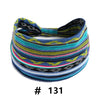 A colorful, striped knitted headband with a bow, featuring various shades of blue, green, yellow, and black.