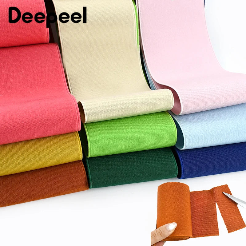 A collection of colorful, adjustable elastic bands or ribbons in various shades are displayed on a white surface.