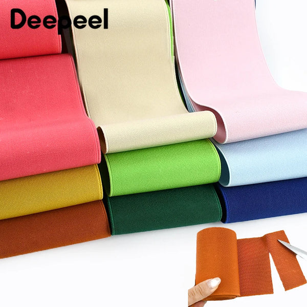 A collection of colorful, adjustable elastic bands or ribbons in various shades are displayed on a white surface.