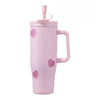 A pink insulated thermos mug decorated with heart-shaped pearl inlays.