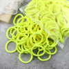 A pile of bright yellow elastic hair bands in various sizes and colors, packaged in clear plastic.
