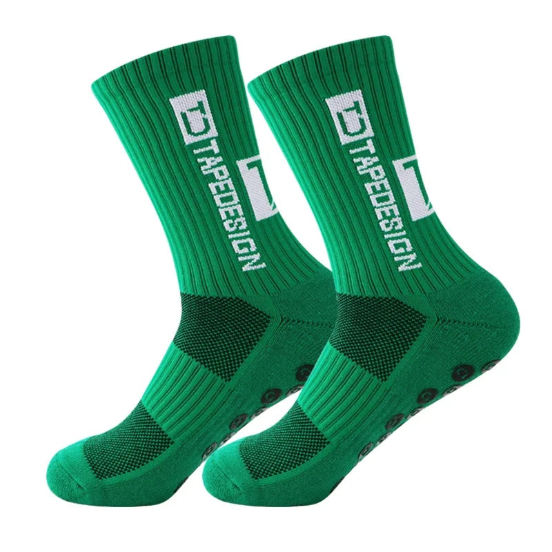 A pair of green anti-slip performance sports socks with white text and diamond patterns.