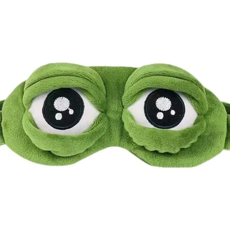 A green frog-themed sleep eye mask with large, round eyes.