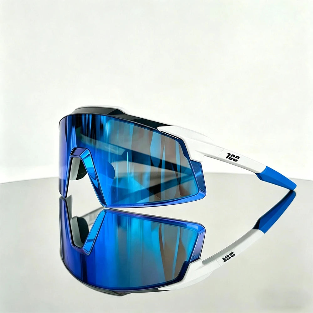 A pair of blue mirrored sports sunglasses with white frames resting on a reflective surface.