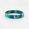 A silicone wristband with a green and blue marbled pattern featuring the number 5 and the name ASL.