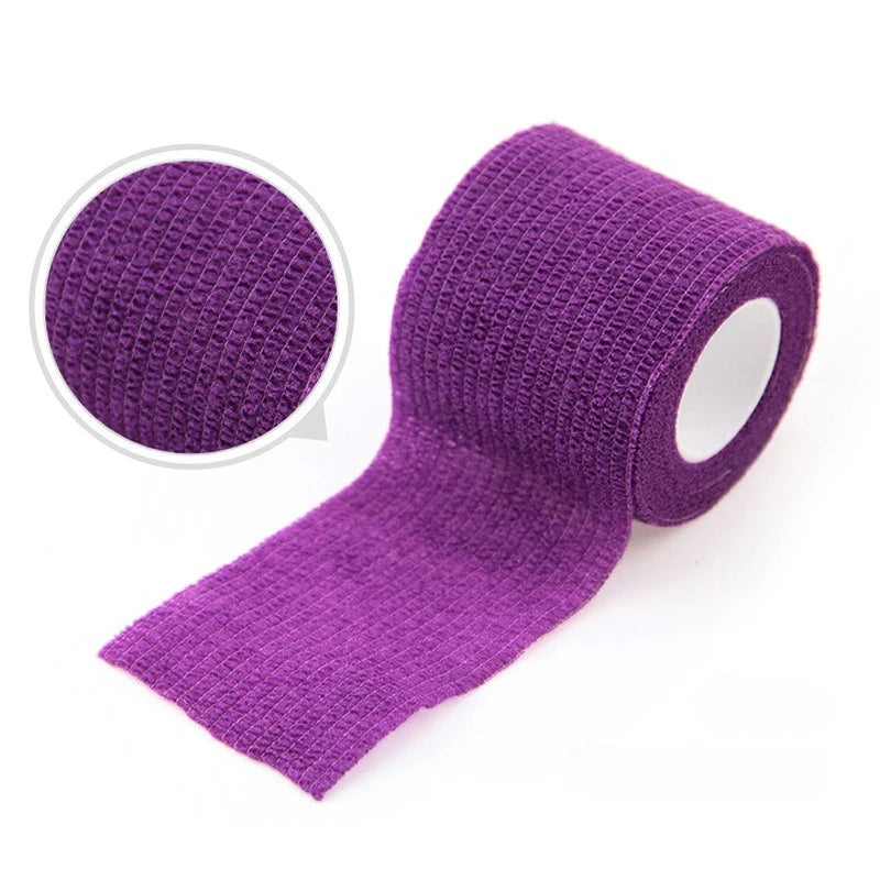 Purple self-adhesive elastic bandage tape rolled and unrolled, showing a close-up texture.