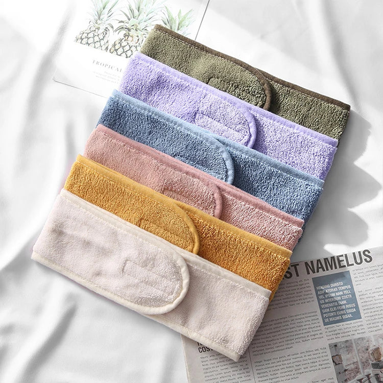 A stack of colorful faux fur and acrylic hair accessories in various shades of purple, blue, green, and beige.
