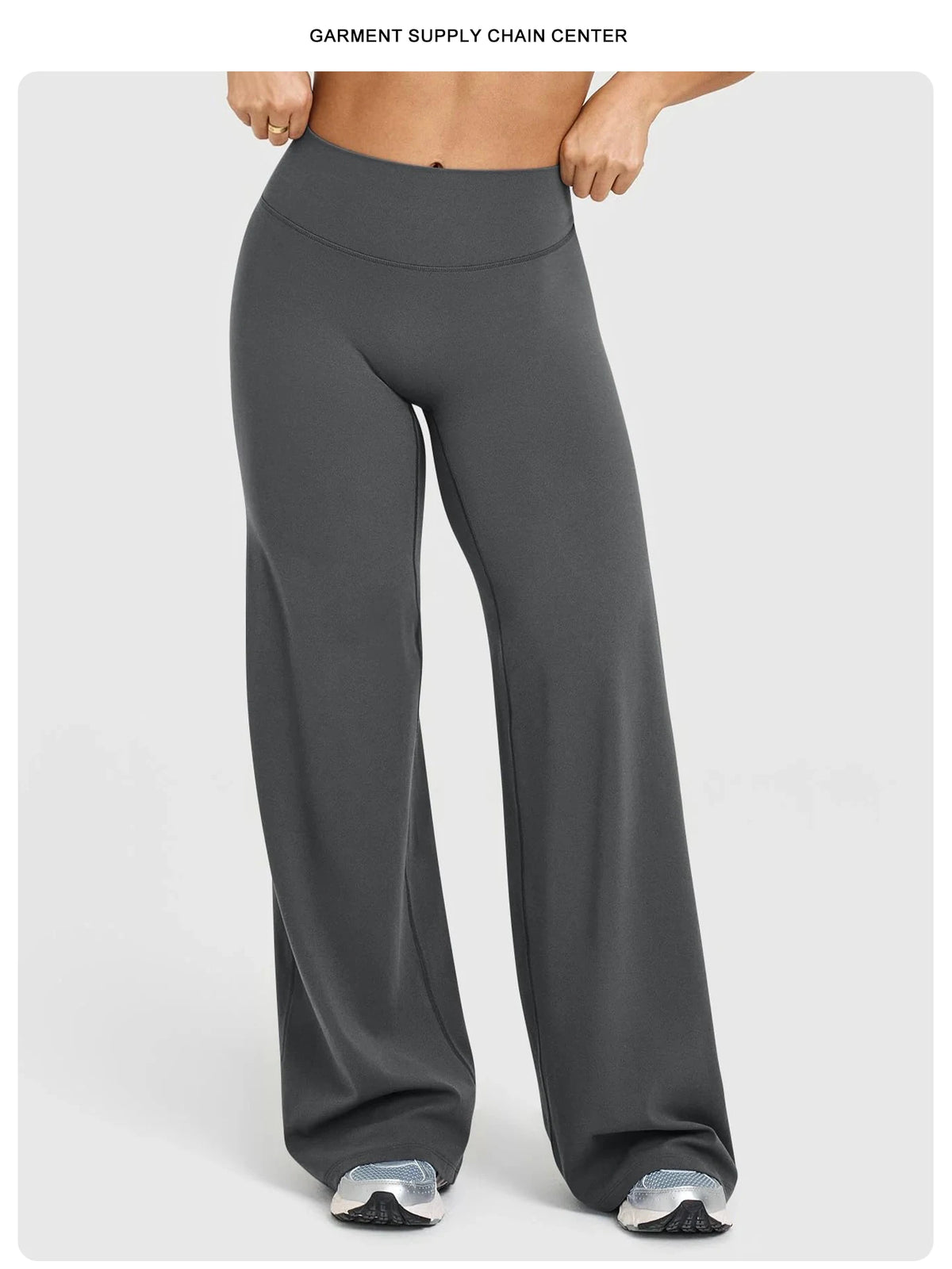 A model is wearing dark gray high waisted wide leg yoga pants in a studio setting.
