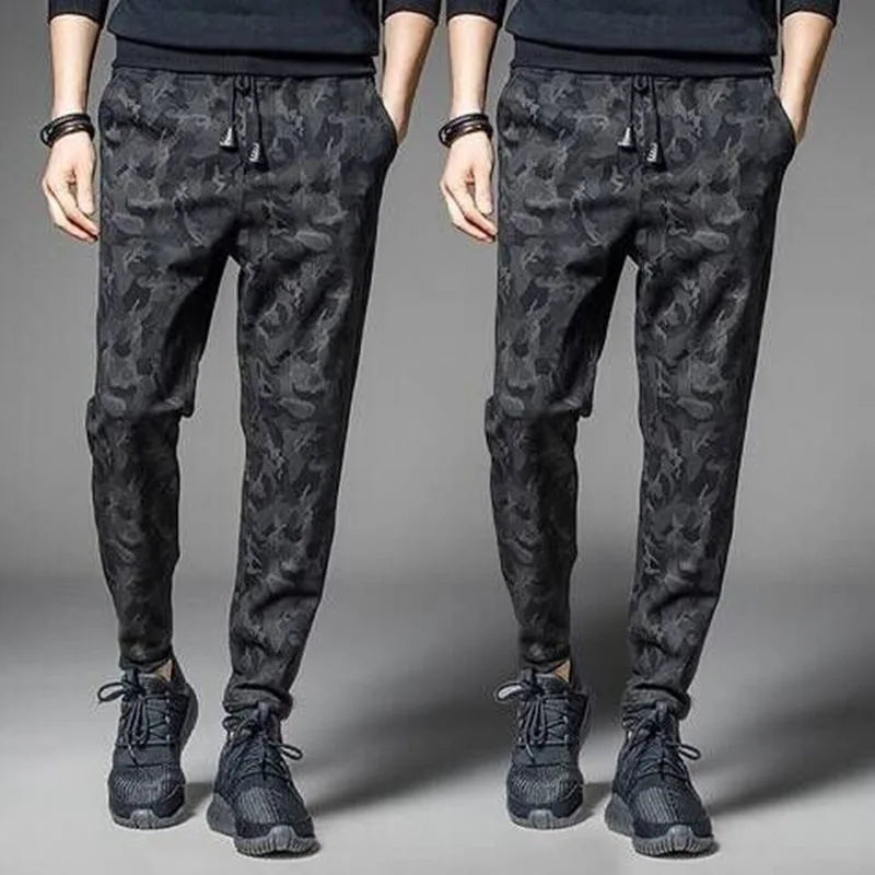 Men's camouflage elastic waist drawstring pants shown on a model.