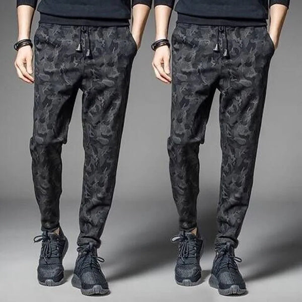 Men's camouflage elastic waist drawstring pants shown on a model.