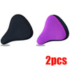 A pair of purple and black breathable 3D mesh bicycle saddle cushions.
