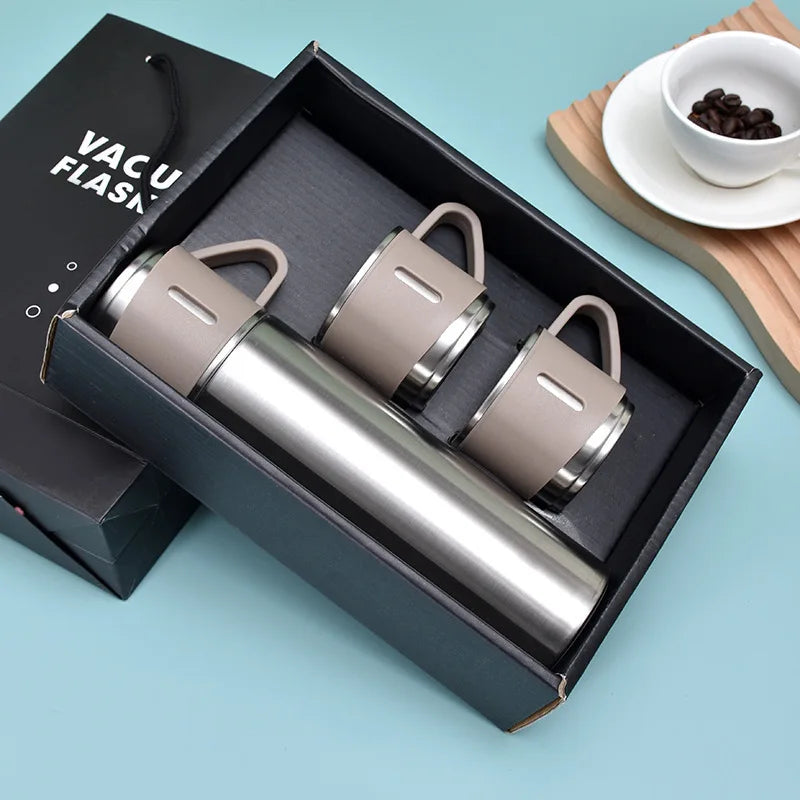 A dark box contains a stainless steel vacuum flask and a lid on a light blue background.
