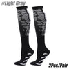 A pair of black light gray patterned sport compression socks shown against a white background.