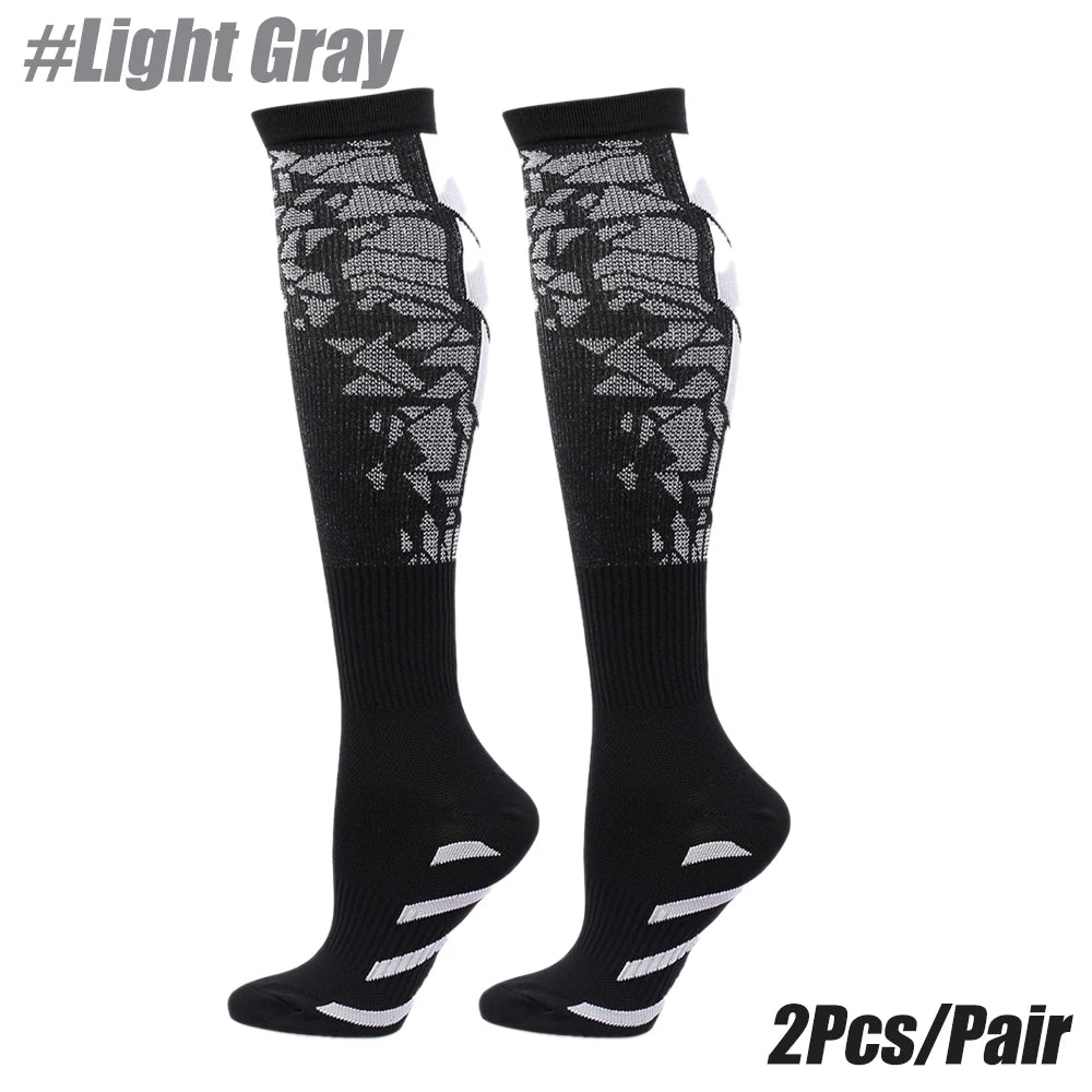 A pair of black light gray patterned sport compression socks shown against a white background.