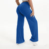 A person wearing royal blue NCLAGEN SoftMotion Straight Leg Yoga Pants standing and looking down.