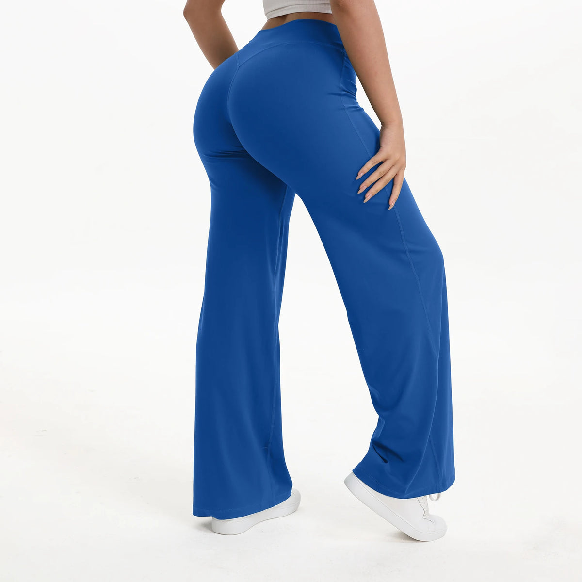 A person wearing royal blue NCLAGEN SoftMotion Straight Leg Yoga Pants standing and looking down.