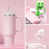 A pink tumbler is shown next to a green silicone straw cover and a white cloud-shaped straw cover.