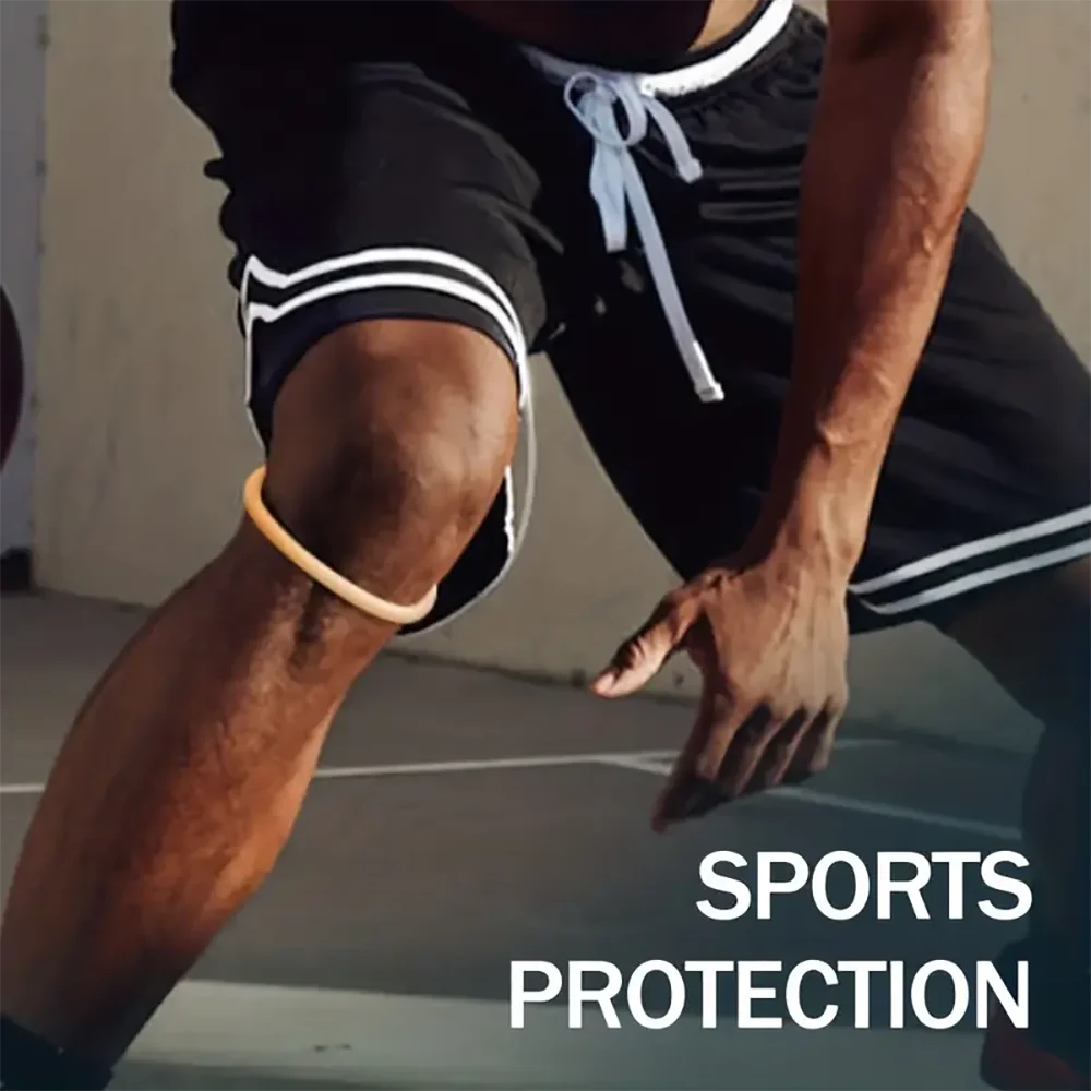 A close-up of a person wearing a black knee brace strap for sports protection during physical activity.