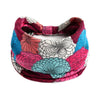 A colorful, patterned bohemian cotton stretch headband featuring floral and mandala designs.