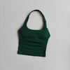 A dark green seamless yoga and pilates sports bra displayed against a white background.