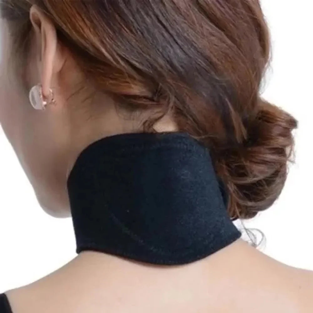 A close-up of a woman wearing a black self-heating neck support brace on the back of her neck.