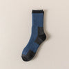 A dark blue merino wool thermal hiking sock with black accents, shown against a light background.