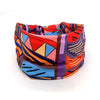 A colorful bohemian stretch cotton headband featuring geometric patterns in shades of orange, purple, blue, and pink.