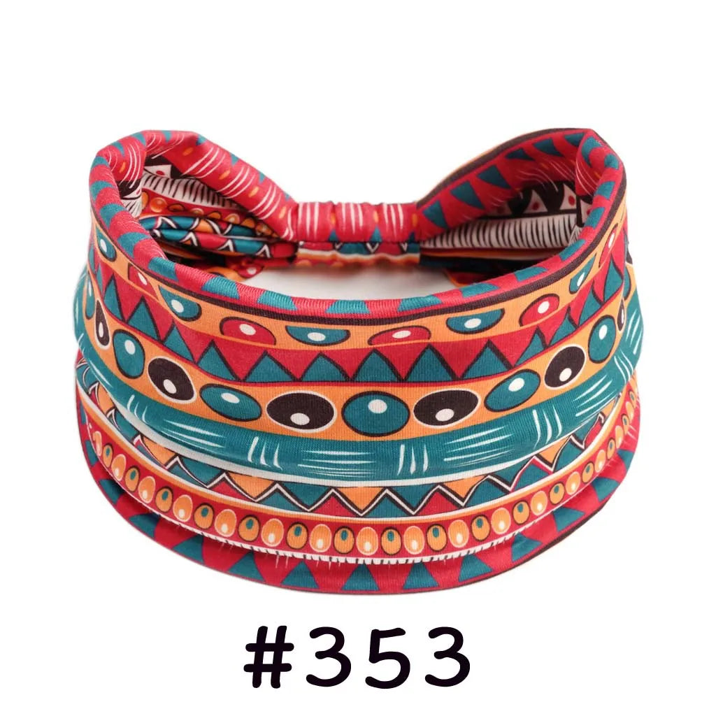 A colorful, patterned boho knotted cotton headband featuring geometric designs in red, orange, and teal.