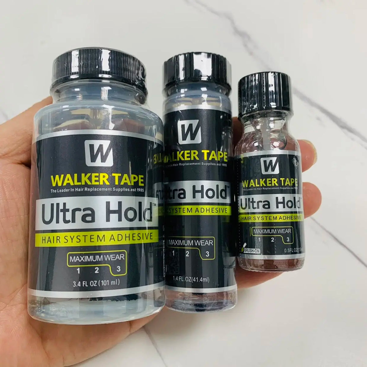 Three bottles of Walker Tape Ultra Hold hair system adhesive for lace wigs and hair replacement