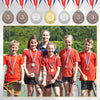 A group of six students standing in front of a display of gold, silver, and bronze award medals with ribbons.