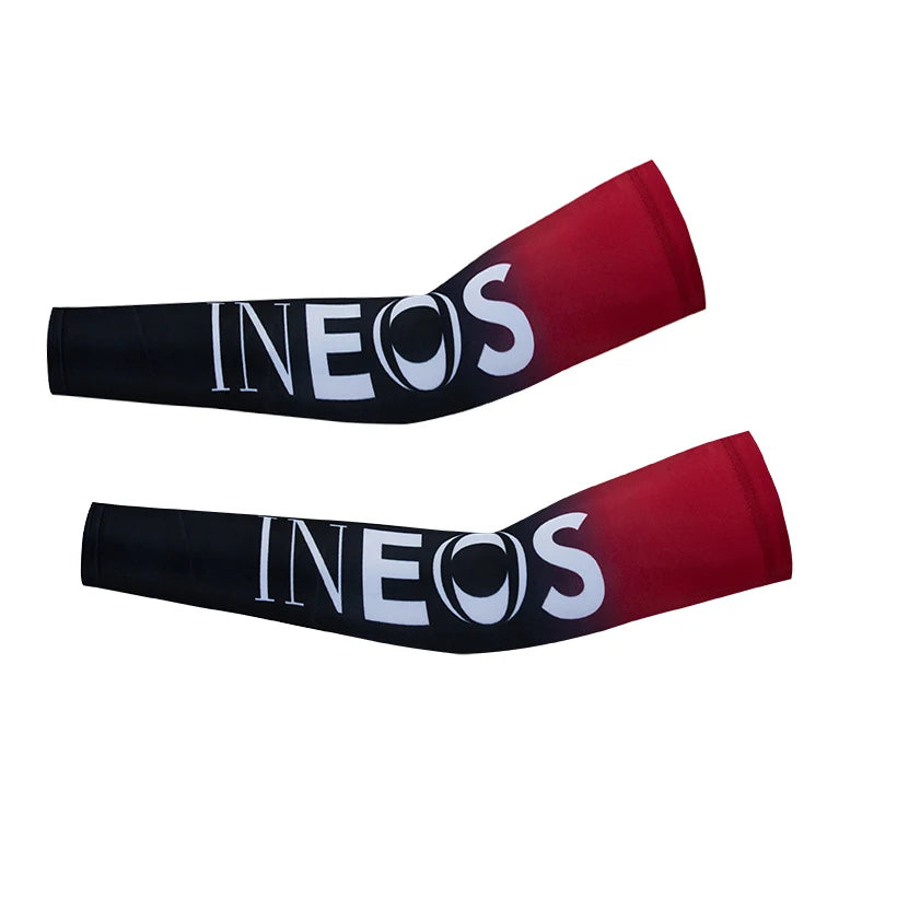 A pair of red and black cycling arm warmers with the brand name INEOS printed on them.