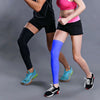A person wearing black athletic shorts and a pink top is demonstrating performance knee calf compression sleeves on their leg