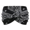 Black fabric yoga headband with white paisley print tied in a bow