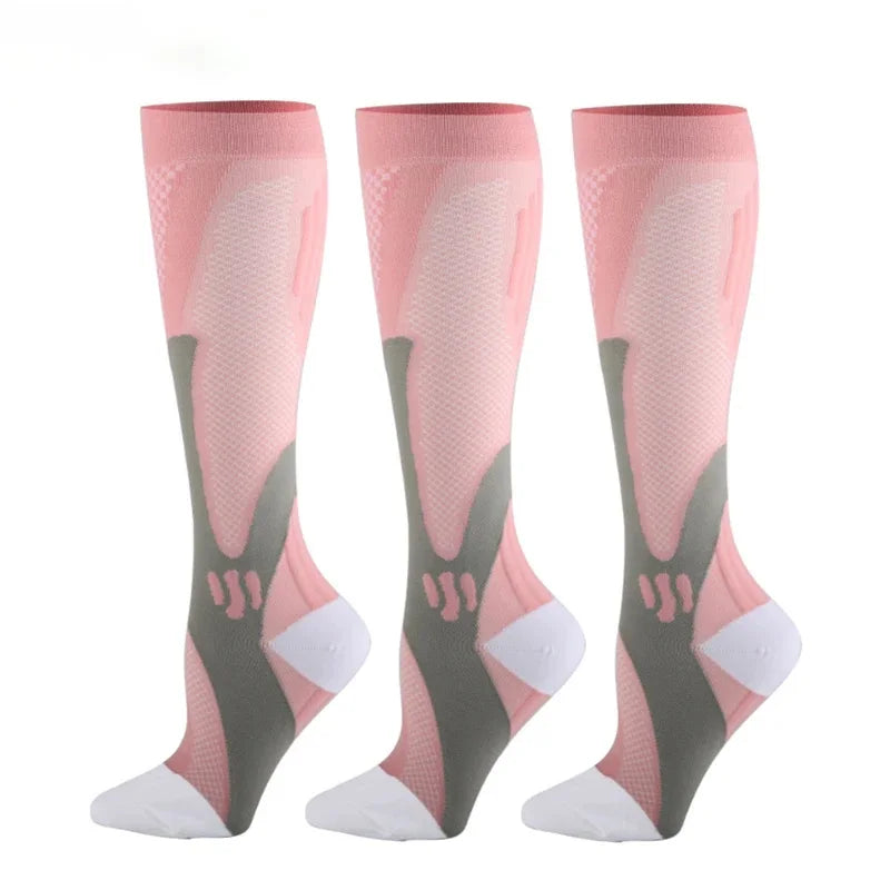 A set of three pink compression socks with gray and white accents shown standing vertically.