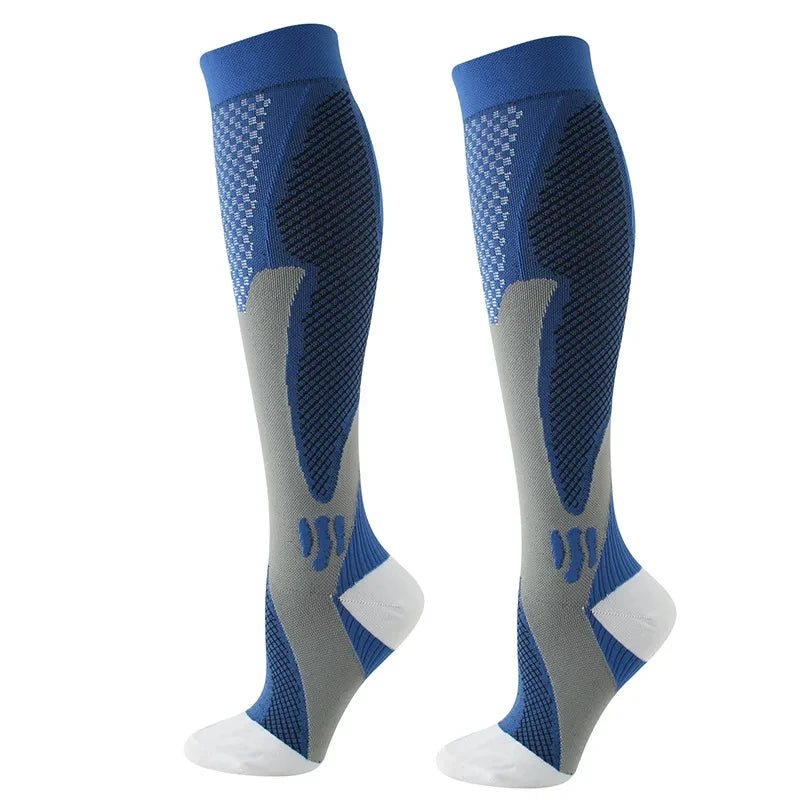 A pair of navy blue compression socks with gray accents and white tips.