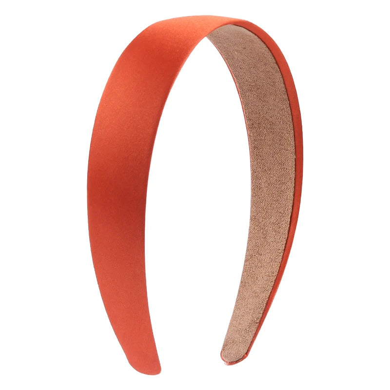A pair of solid satin hair bands in a burnt orange color shown against a white background.