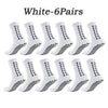 Six pairs of white athletic grip socks with a geometric pattern displayed together.