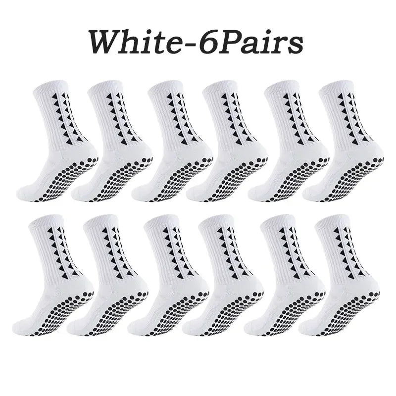 Six pairs of white athletic grip socks with a geometric pattern displayed together.
