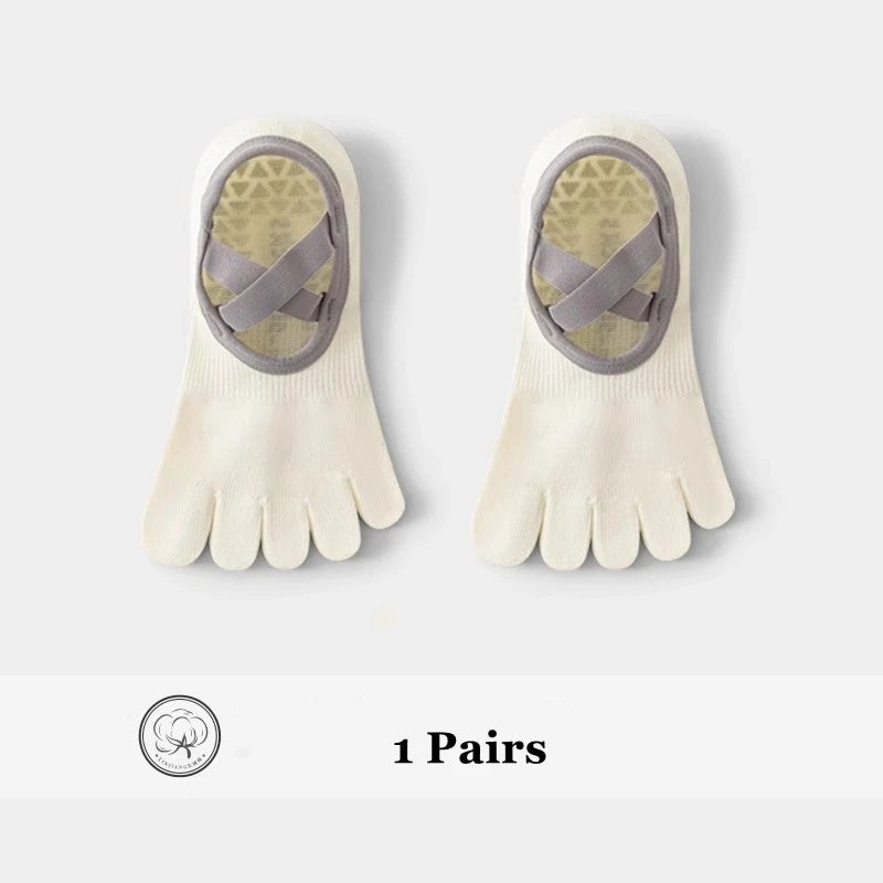 A pair of beige five-finger yoga and fitness socks with a patterned design on the top