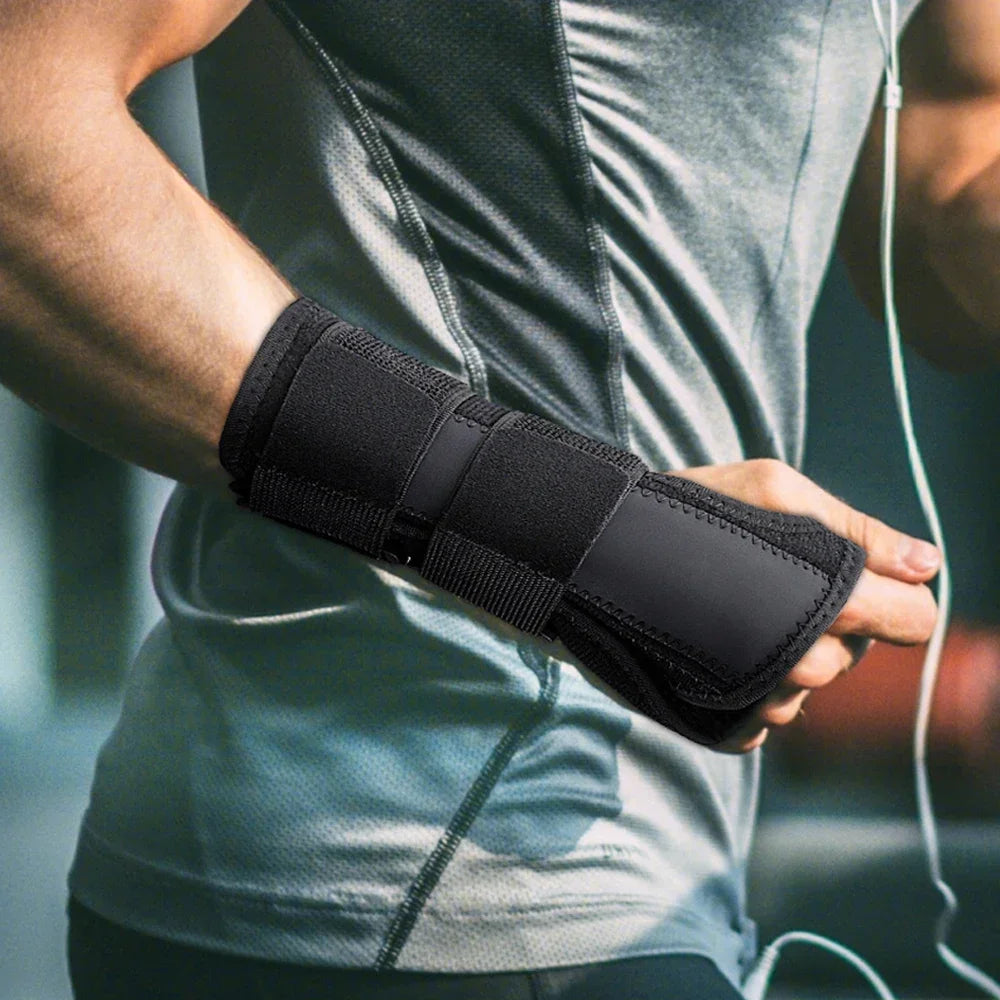 A person wearing a black supportive wrist splint for pain relief on their forearm.