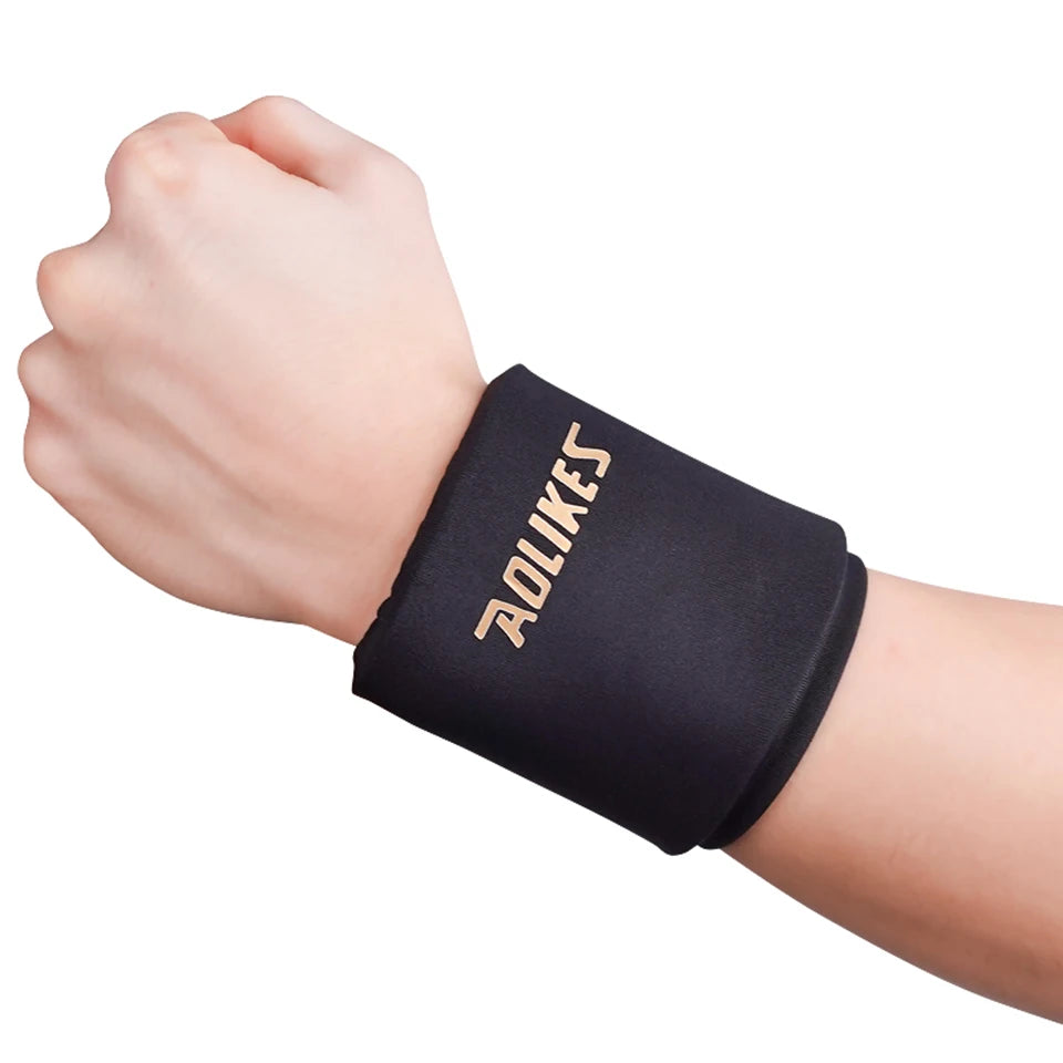 A hand wearing a black knee sleeve with the word 'SOLKES' printed on it.