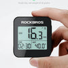 A hand holds a black Rockbros GPS cycling computer displaying a speed of 16.3 km/h and time.