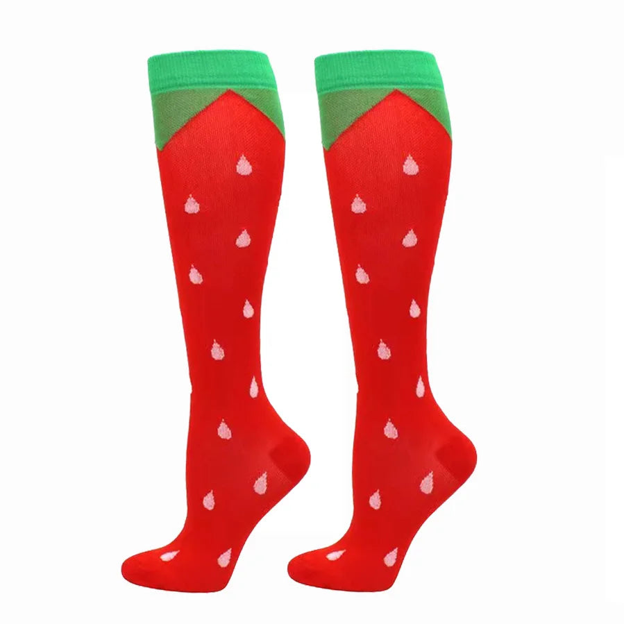 Pair of red compression elastic socks with green cuffs and white dots